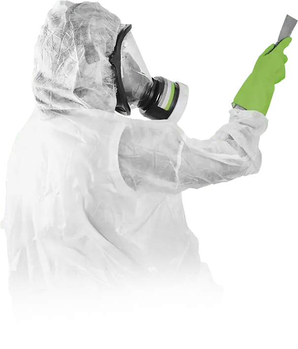 Asbestos abatement technician in a white protective suit and respirator holding a scraper